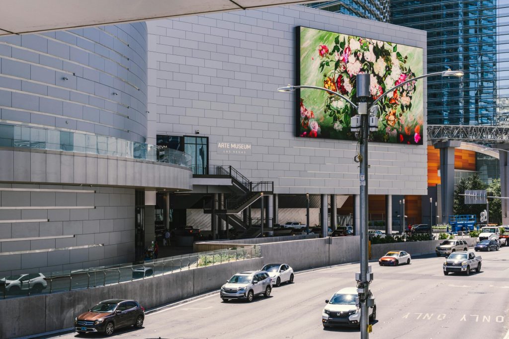 Street view of Arte Museum in Las Vegas showcasing vibrant digital art on a sunny day.