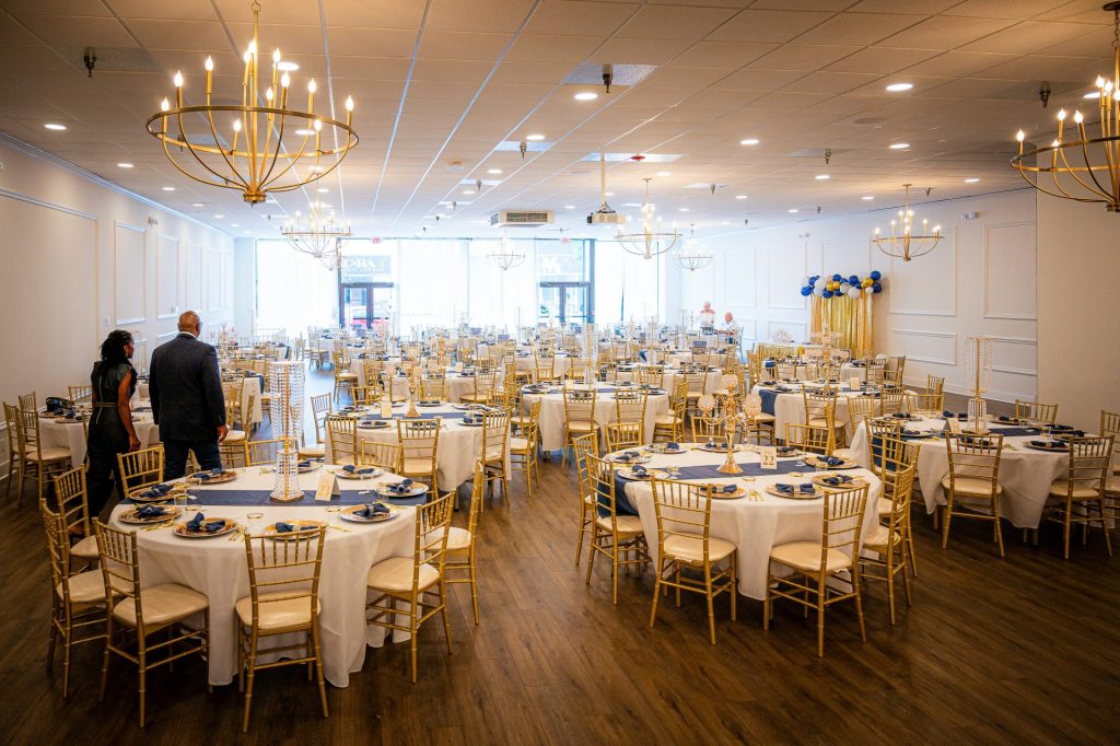 Elegant banquet hall set for an event with round tables.