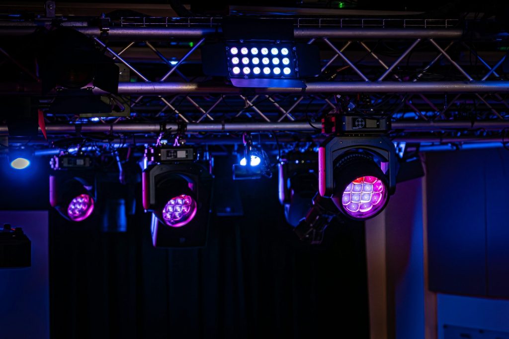 Stage lights illuminating in purple and blue.